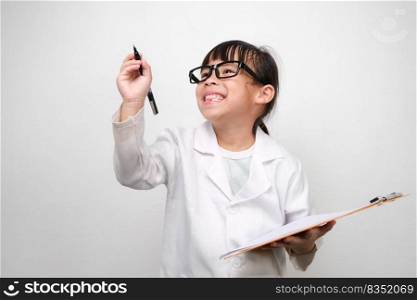 Portrait of a little scientist holding a clipboard with a pen thinking on a white background. A little girl role playing in a doctor or science costume.