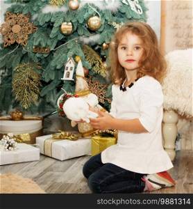 Portrait of a lovely little girl. Portrait of cute little girl among Christmas decorations