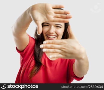 Portrait of a lovely woman framing her face with her hands and smiling