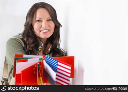 Portrait of a lovely young woman with different countries flags smiling