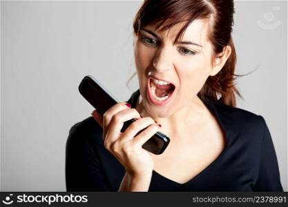 Portrait of a mad woman shouting to the cellphone