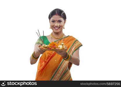 Portrait of a Maharashtrian woman holding a puja thali