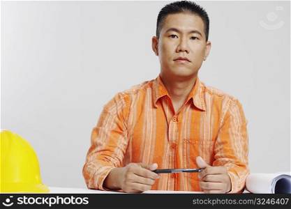 Portrait of a male architect holding a pen