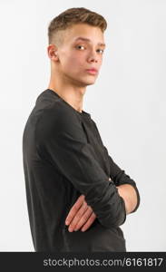 portrait of a male caucasian teenager on gray background. portrait of a teenager