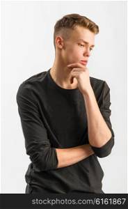 portrait of a male caucasian teenager on gray background. portrait of a teenager