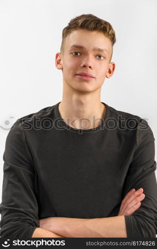 portrait of a male caucasian teenager on gray background. portrait of a teenager