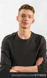 portrait of a male caucasian teenager on gray background. portrait of a teenager