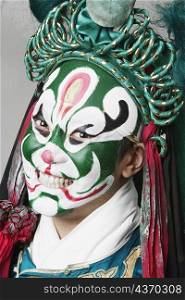 Portrait of a male Chinese opera performer clenching his teeth
