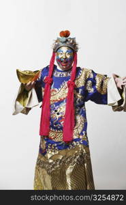 Portrait of a male Chinese opera performer holding a bowl full of gold coins