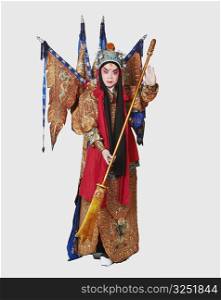 Portrait of a male Chinese opera performer holding a weapon