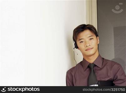 Portrait of a male customer service representative holding a file and a mobile phone