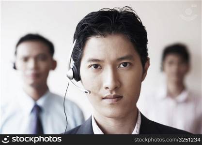 Portrait of a male customer service representative with two colleagues