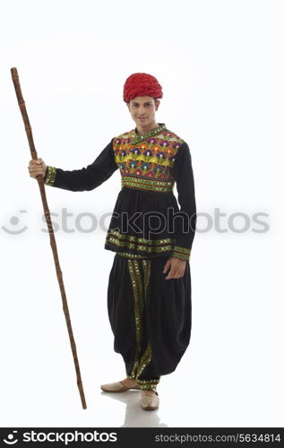 Portrait of a male dandiya dancer with a stick