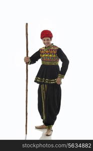 Portrait of a male dandiya dancer with a stick