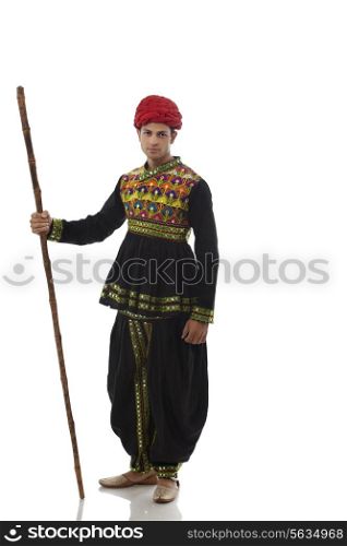 Portrait of a male dandiya dancer with a stick