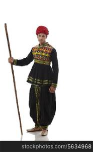 Portrait of a male dandiya dancer with a stick