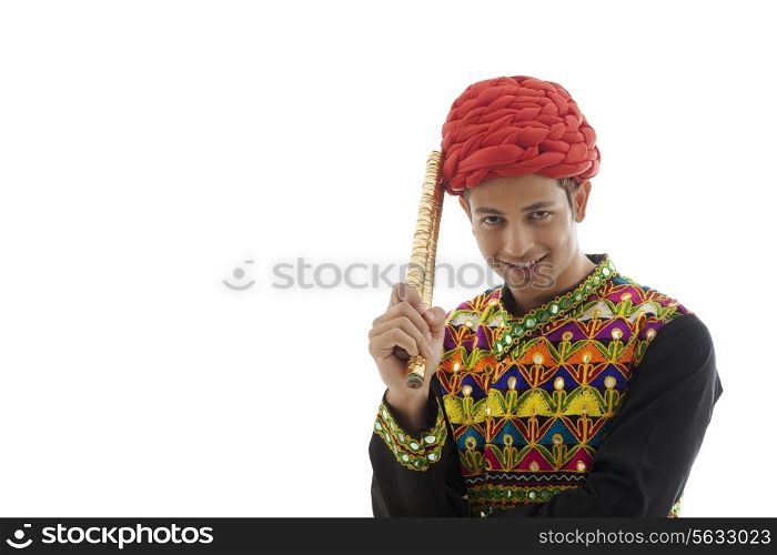 Portrait of a male dandiya dancer with sticks
