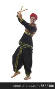 Portrait of a male dandiya dancer with sticks