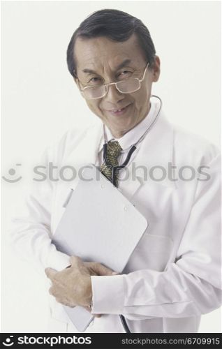 Portrait of a male doctor holding a clipboard smiling