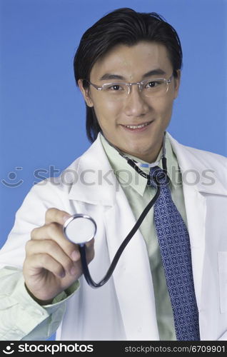 Portrait of a male doctor holding a stethoscope