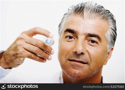 Portrait of a male doctor holding a syringe