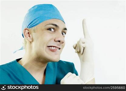 Portrait of a male doctor wearing surgical gloves