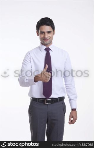 Portrait of a male executive giving thumbs up