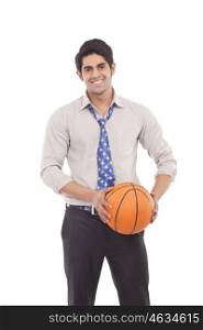 Portrait of a male executive with a basketball