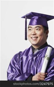 Portrait of a male graduate holding a diploma