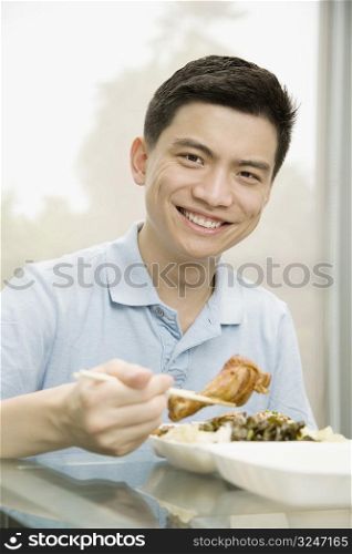Portrait of a male office worker having lunch and smiling