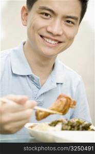 Portrait of a male office worker having lunch and smiling