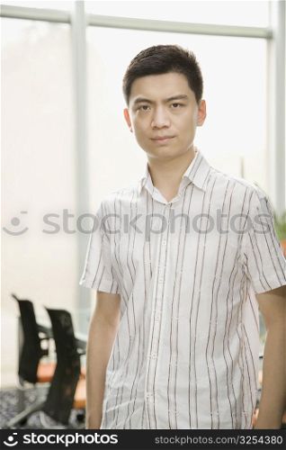 Portrait of a male office worker standing in an office