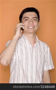 Portrait of a male office worker talking on a mobile phone and smiling