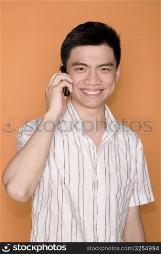 Portrait of a male office worker talking on a mobile phone and smiling