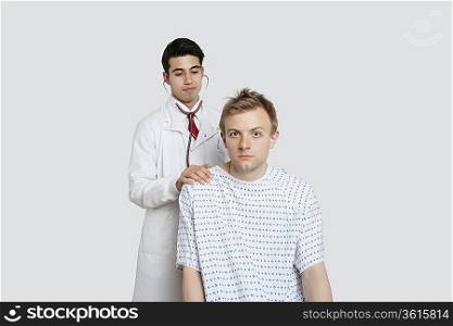Portrait of a male patient being treated by an Indian doctor