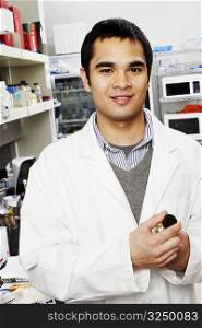 Portrait of a male pharmacist standing in a laboratory