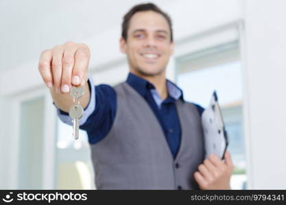 portrait of a male realtor holding keys