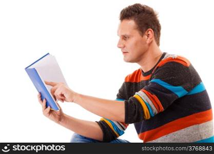 Portrait of a male student sitting reading a book preparing for exam isolated on white