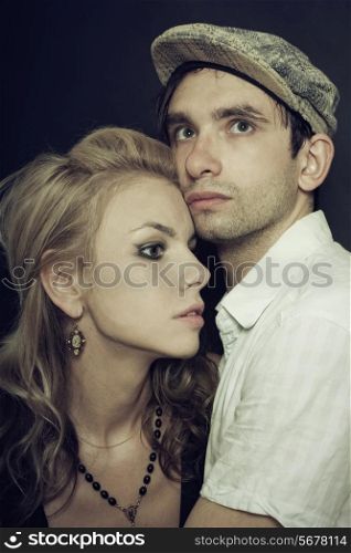 portrait of a man and woman embracing on a black background