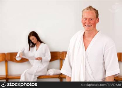 Portrait of a man at a spa with a woman in the background