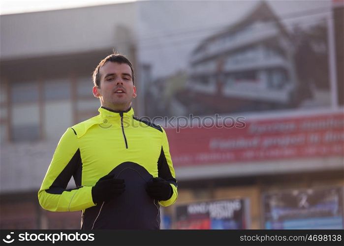 portrait of a man at jogging at cold autumn mornigng