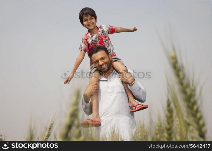 Portrait of a man carrying little boy on shoulders