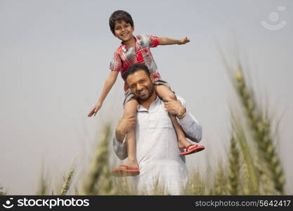 Portrait of a man carrying little boy on shoulders