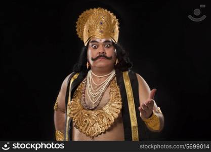Portrait of a man dressed as Raavan gesturing