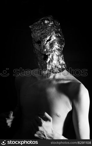 Portrait of a man dressed in scary masks foil closeup