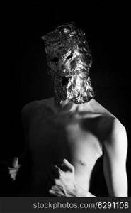Portrait of a man dressed in scary masks foil closeup