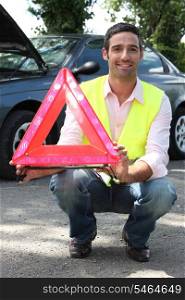 portrait of a man holding safety triangle