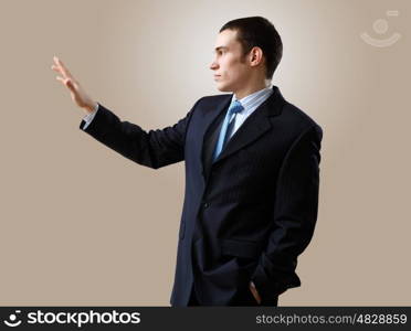 Portrait of a man in business wear making presentation