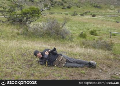 Portrait of a man lying on the grass, Patagonia, Chile
