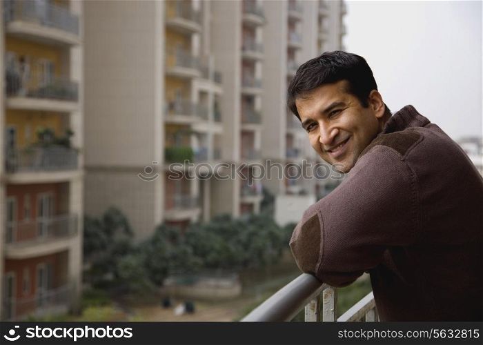 Portrait of a man on a balcony smiling